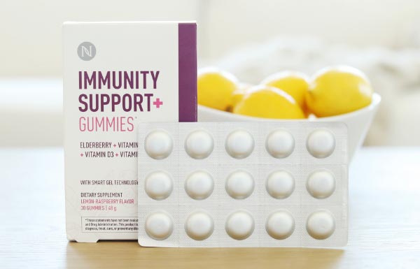 Lifestyle shot of the Immunity Support+ Gummies packaging in front of a bowl of lemons.
